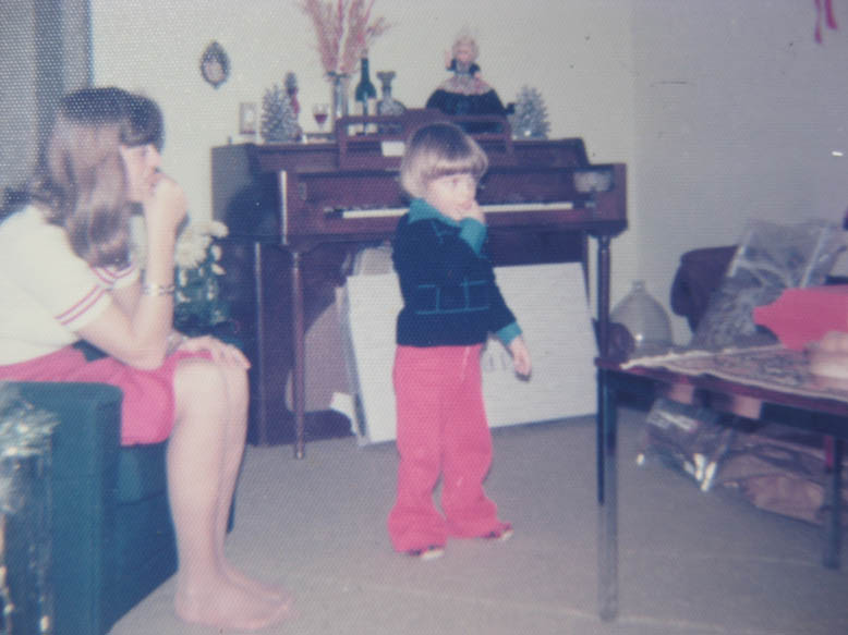 Lucien Desar age 4 in front of piano